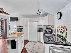 Fridge, microwave, coffee/tea maker, cookware/dishes/utensils