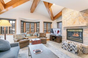 A spacious living room with a fireplace, comfortable seating, and a television. - Ski In/Out at Gondola One Vail Slopeside Lodge 401 (Vail)
