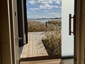 A wooden pathway leading to a beach with a rope barrier.