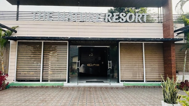 A modern building with a sign reading "THE NATURE RESORT" and a reception area visible through the entrance. - The Nature Resort (Rishikesh)