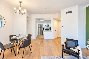 A modern interior with a dining area, a living room, and a kitchen. - Diablo Stadium & ASU- Gym,Pool,HotTub,Parking,WD (Tempe)
