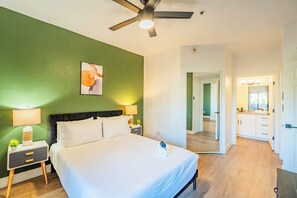 A bedroom with a bed, nightstands, a ceiling fan, and a green wall. - Diablo Stadium & ASU- Gym,Pool,HotTub,Parking,WD (Tempe)