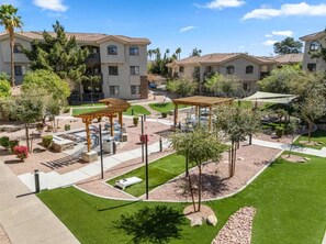 A residential complex with multiple apartment buildings, a central courtyard with a pergola, and well-maintained landscaping. - Near Diablo Stadium & ASU-HotTub,Pool,Gym,Parking (Tempe)