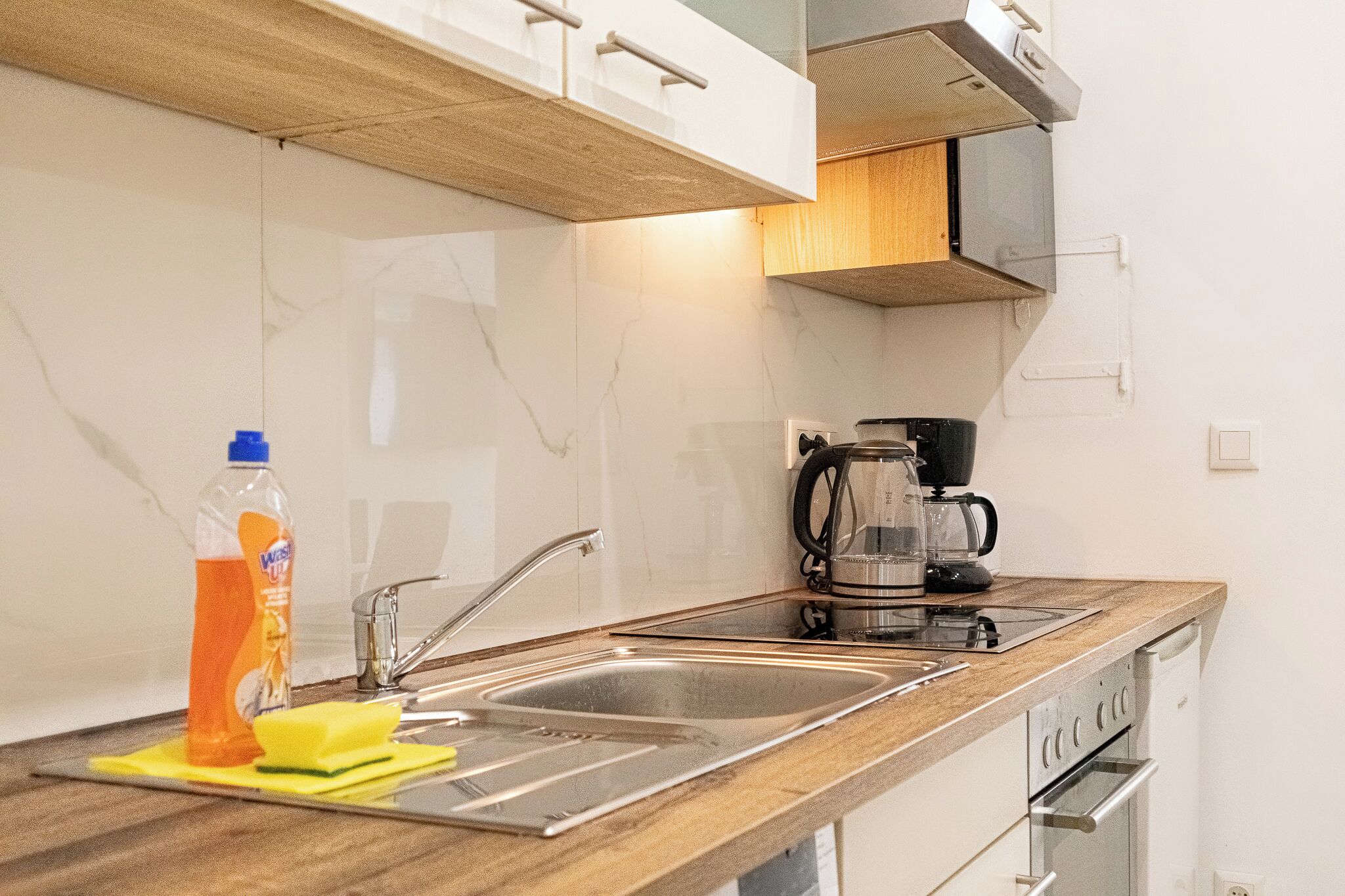 Eenvoudig appartement | Privékeuken | Een minikoelkast, een kookplaat, kookgerei, borden en bestek