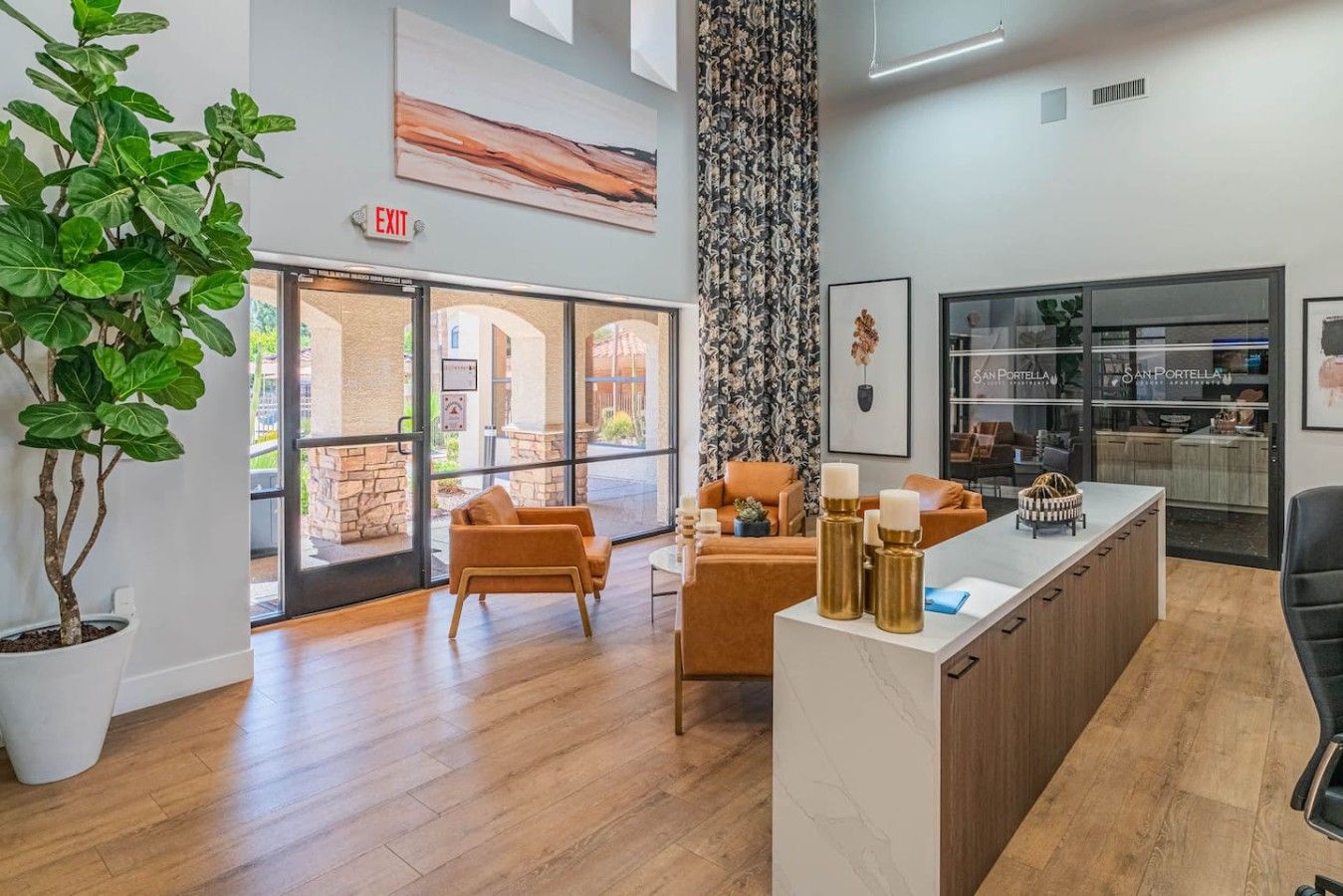 A modern reception area with a wooden reception desk, seating area with chairs, a large window, and a potted plant.