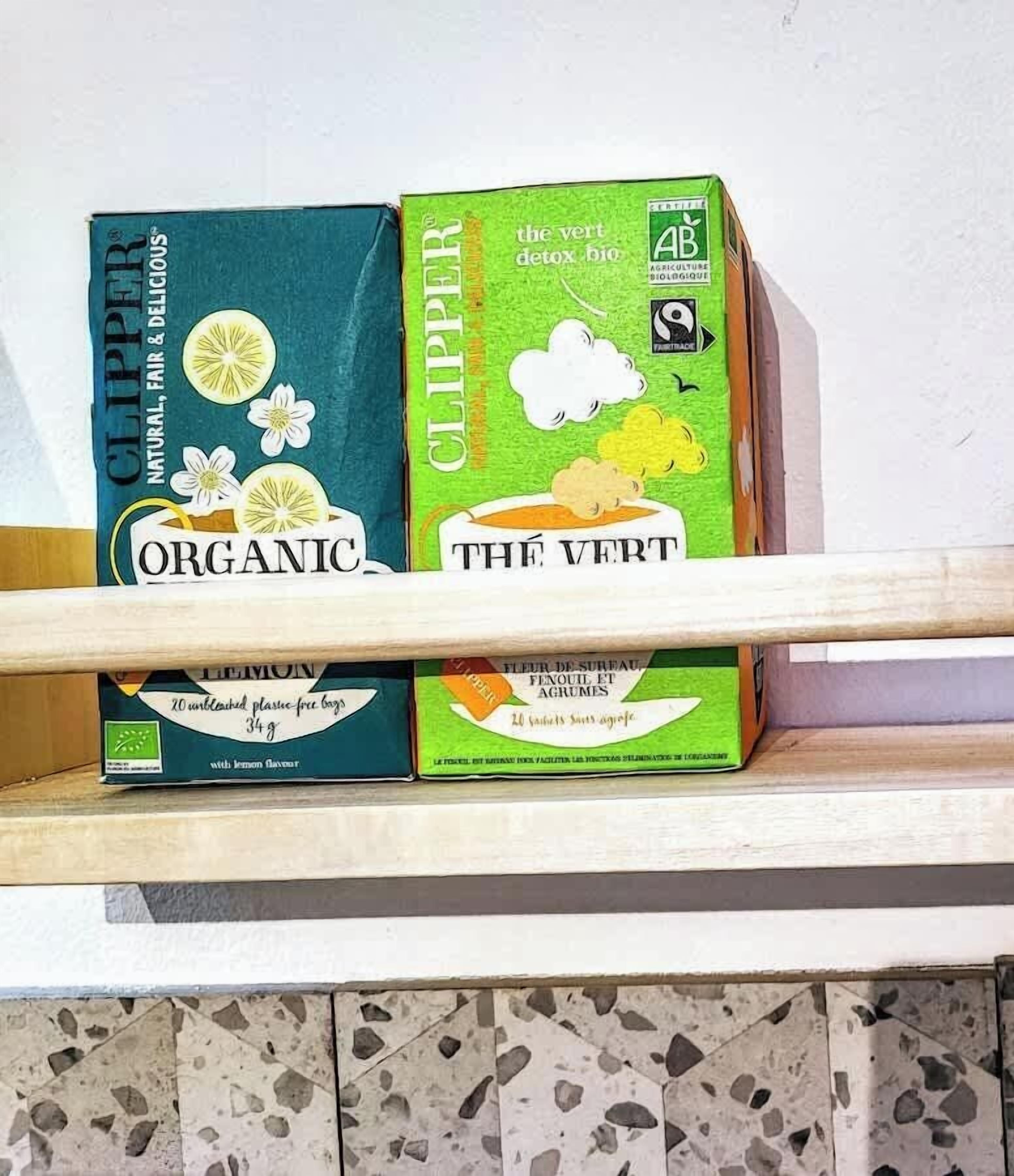 Two boxes of organic Clipper tea on a shelf.