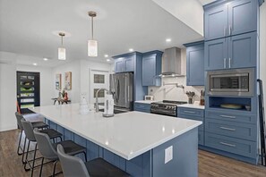 Fridge, microwave, oven, stovetop - Coastal Luxe Retreat | Team Joseph Ellen (Palm Coast)