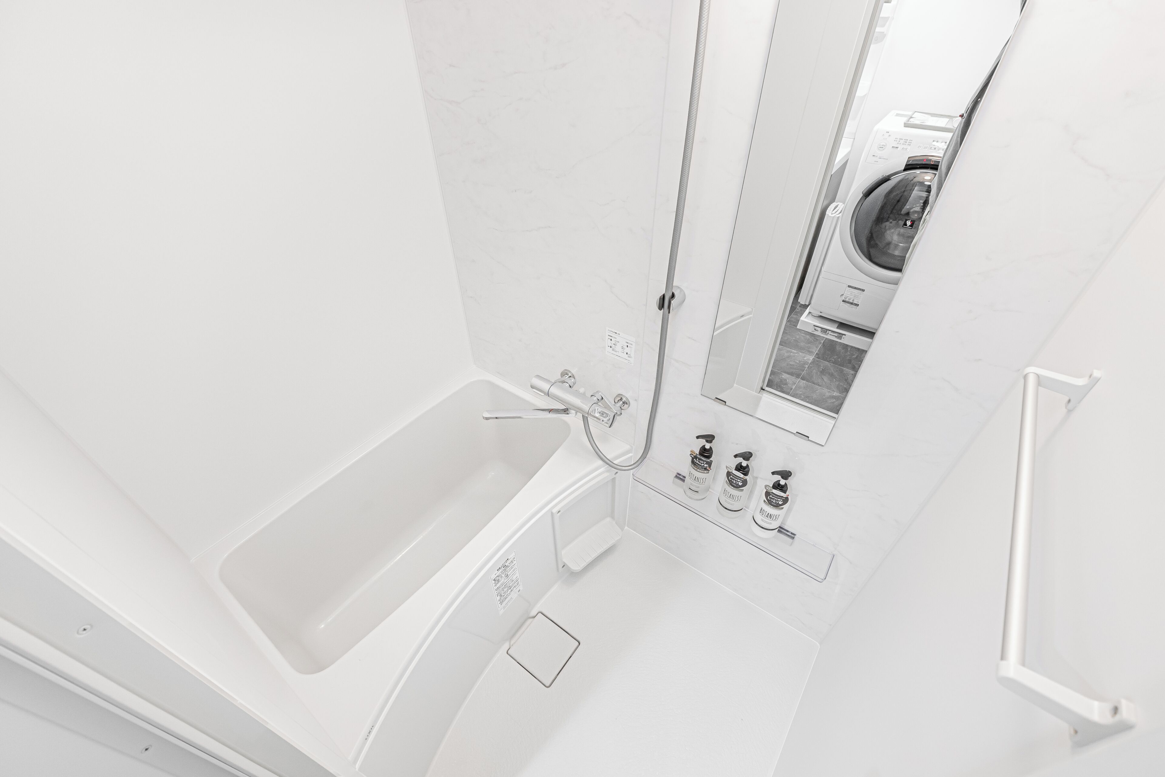 Separate tub and shower, hair dryer, slippers, towels