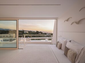 A bedroom with a large bed, a view of the cityscape, and a balcony. - Lagon Life Spirit Design Villas - Adults Only (Chania)