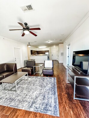 Signature Apartment, 4 Bedrooms, Pool Access | Living room | 55-inch Smart TV with digital channels