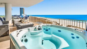 A hot tub on a balcony with a view of the ocean and beach. - Breathtaking beach views from every room! Spacious, luxurious, hot tub and grill on private balcony! (Orange Beach)