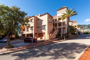 A multi-story building with balconies, a staircase, and a clear sky. - Resort Mediterra III | Modern Apartment with Sea & Mountain Views, Terrace & Pools in Benalmadena (Benalmádena)