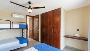 A room with bunk beds, a wardrobe, a ceiling fan, and a small shelf with a tissue box. - Casa Nido de Mar 9 Persons Occupancy Pool 7 Beds (Nuevo Nayarit)