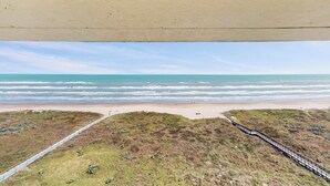 A beach view with a wooden boardwalk leading to the shore. - Walkable, All-suite 3br: Suntide III - Unit 1003 (South Padre Island)