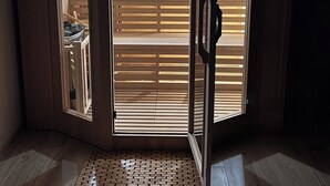 A sauna with a wooden interior, a visible clock, and a bench. - Jacuzzi, Sauna, Private - Escape at your fingertips (Aspach-le-Bas)