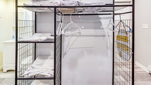 A metal bunk bed with white towels and hangers. - 8 Mi to Dtwn Cle: Cozy Couple's Retreat w/ Gym! (Cleveland)
