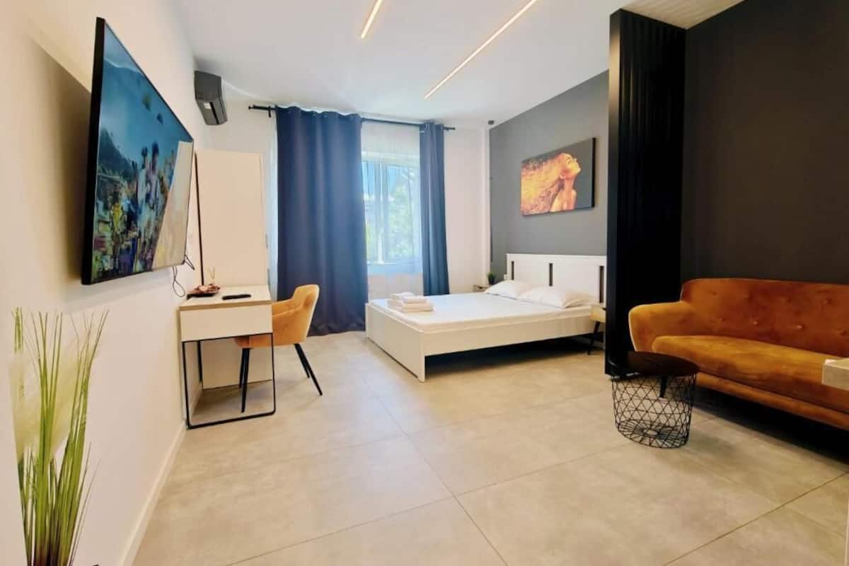 Hypo-allergenic bedding, desk, laptop workspace, blackout drapes