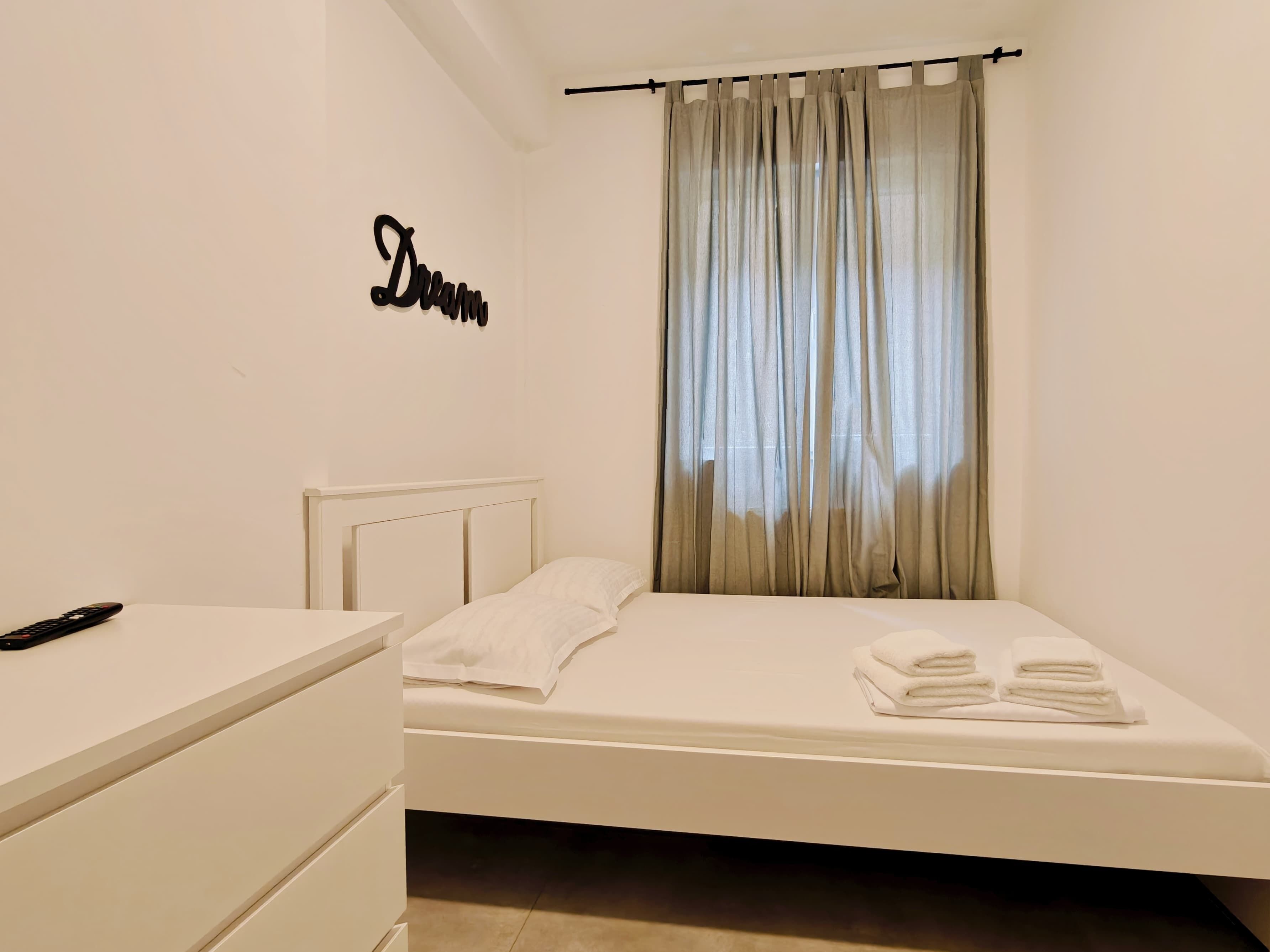 Hypo-allergenic bedding, desk, laptop workspace, blackout drapes