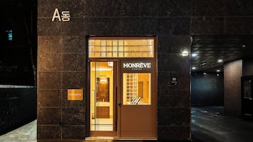 A hotel entrance with a sign for 'MONREVE CABINS' and a 'WASH ZONE' visible inside.