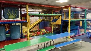 An indoor play area with a ping pong table, colorful play structures, and a ball pit. - Static Caravan Mallard Rise 22 Hoburne Devon Bay (Paignton)