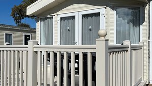 A white mobile home with a balcony and a covered porch. - Static Caravan Mallard Rise 22 Hoburne Devon Bay (Paignton)