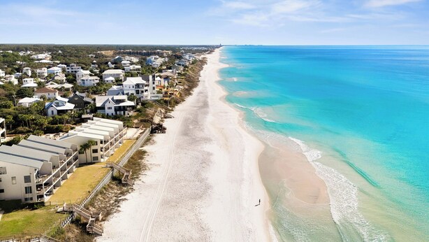 An aerial view of a coastal residential area with beachfront properties, a sandy beach, and a clear blue ocean. - Crow's Nest at Blue Mountain Beach - Ocean View - Private Beach Access (Santa Rosa Beach)