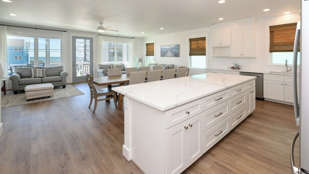 A spacious kitchen with a large island, white cabinetry, and a dining area with a table and chairs. - BIG VIEW. New 2026. 7 BR/7.5 BT, private 25'x15' pool, elevator, Surfside Beach (Surfside Beach)