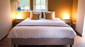 Ein großes Bett mit weißen Bettwäsche und zwei Nachttische mit Lampen.