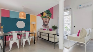 A modern living room with a dining area, a sofa, and a bed. - MOT Rentals + 4Bd with Terrace, Pool & BBQ in La Rural (Buenos Aires)