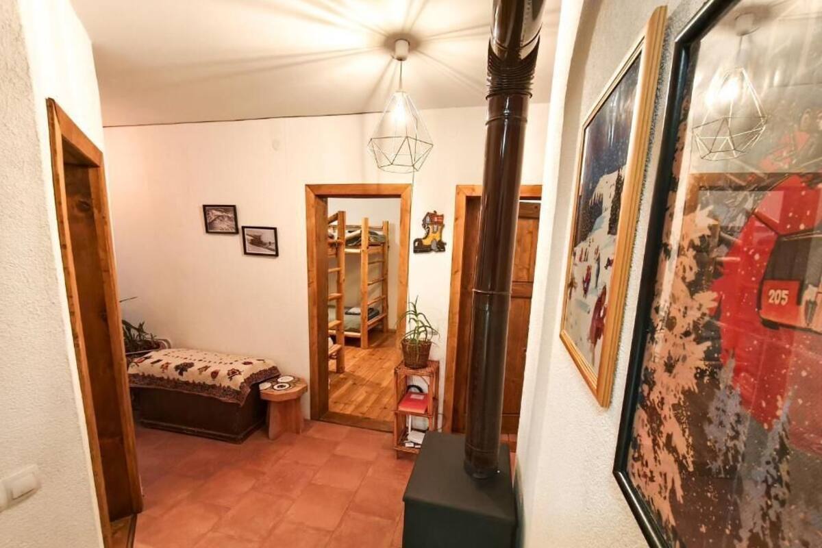 Un corridoio con un letto, una porta in legno, un termosifone a parete e un quadro incorniciato.