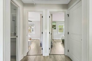 A hallway with white doors leading to a bathroom and a bedroom. - Pet Friendly Family Home Steps to Raleigh Greenway (Raleigh)