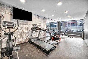 A gym with treadmills, stationary bikes, and weight machines. - Walk to CWRU w KingBed, Balcony, Gym, Parking, WD (Cleveland)