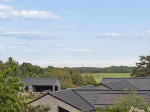 A residential area with multiple houses, a garage, and a green field in the background. - "Cyrill" - 2km from the sea by Interhome (Ebeltoft)