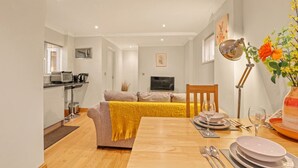 A modern apartment with a dining area, kitchen, and living room. - Roxy`s Cottage - North East Escapes (Beamish)