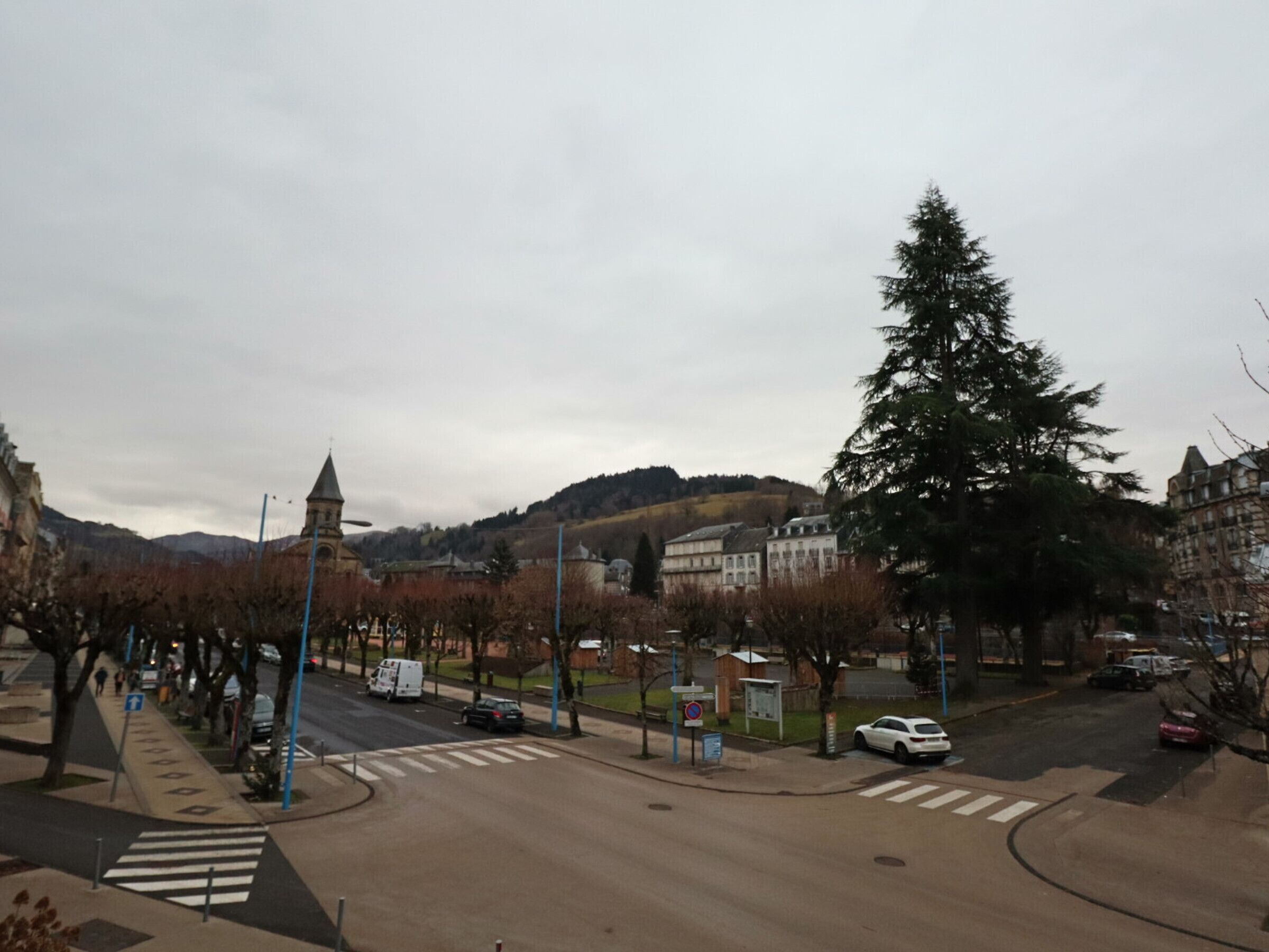 A street view with a pedestrian crossing, a church, and residential buildings.