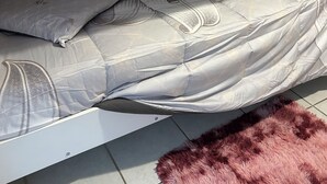A single bed with a floral bedspread, a pink fluffy rug, and a wall with a heart-shaped decoration and the name "ELSA". - Bright private bedroom with desk  (Lyon)
