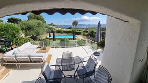 A patio with outdoor furniture, a pool, and a view of the landscape. - VILLA LE CLOS BUCCI WITH PRIVATE POOL AND SUPERB SEA VIEW LES HAUTS DE GRIMAUD (Grimaud)