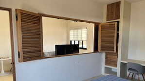 A bedroom with a bed, a desk, and a chair. - BRIGHT & COZY 1-KING BEDROOM CASITA WITH QUEEN SLEEPER IN CENTRAL CERRITOS BEACH (Pescadero)