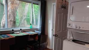 A kitchen with a built-in oven and a window with a view of trees. - Cozy 1-bedroom studio in tranquil Belgrade with AC (Belgrade)