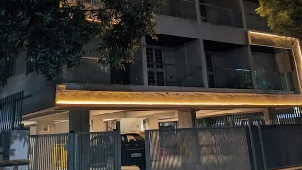 A multi-story building with a modern design, featuring a series of balconies and a gated entrance. - Falcon: Cozy AC Studio Flat by Bleisure Hosting (Pimpri-Chinchwad)