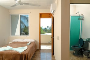 A bedroom with a bed, a ceiling fan, a window, and a view of the outside. - Private Studio-Pool- Walk Everywhere La Punta-Kitchen & Wi-Fi-Optional Breakfast (brisas de zicatela)