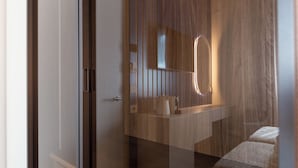 A modern bathroom with a wooden vanity, a mirror, and a towel rack. - MW apartments (Milan)
