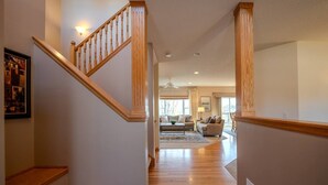 A staircase leading to a living room with a sofa and a coffee table. - Spacious Modern 5-Bed Home –  Near Twin Cities (Rosemount)