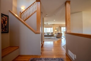 A staircase leading to a living room with a sofa and a coffee table. - Spacious Modern 5-Bed Home –  Near Twin Cities (Rosemount)