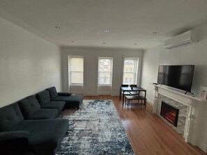 TV, fireplace - Cozy Harlem Brownstone 1BR Washer & Dryer (New York)