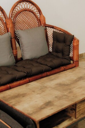 A wicker sofa with cushions and a wooden bench. - Private 1BR - Pool- AC- La Punta - Private Kitchen & Bath (brisas de zicatela)