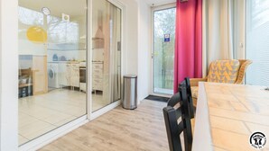 A modern kitchen with a dishwasher, a sink, and a window with a view of the outside. - House Venitia T2 - AUSSONNE (AUSSONNE)