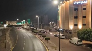 A nighttime view of a street with a building on the right. - asyl hotel (Taif)