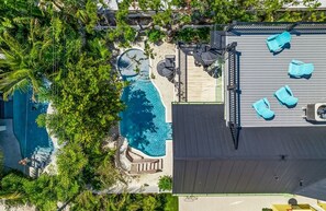 A rooftop pool area with lounge chairs and a small circular pool. - Stunning Home w/ Pool, Slide & Spa & Rooftop Views (Sarasota)