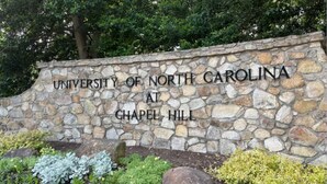 A stone wall with the text 'University of North Carolina at Chapel Hill' engraved on it. - Spacious Retreat w/ King Suite, 3 Baths + Yard (Graham)